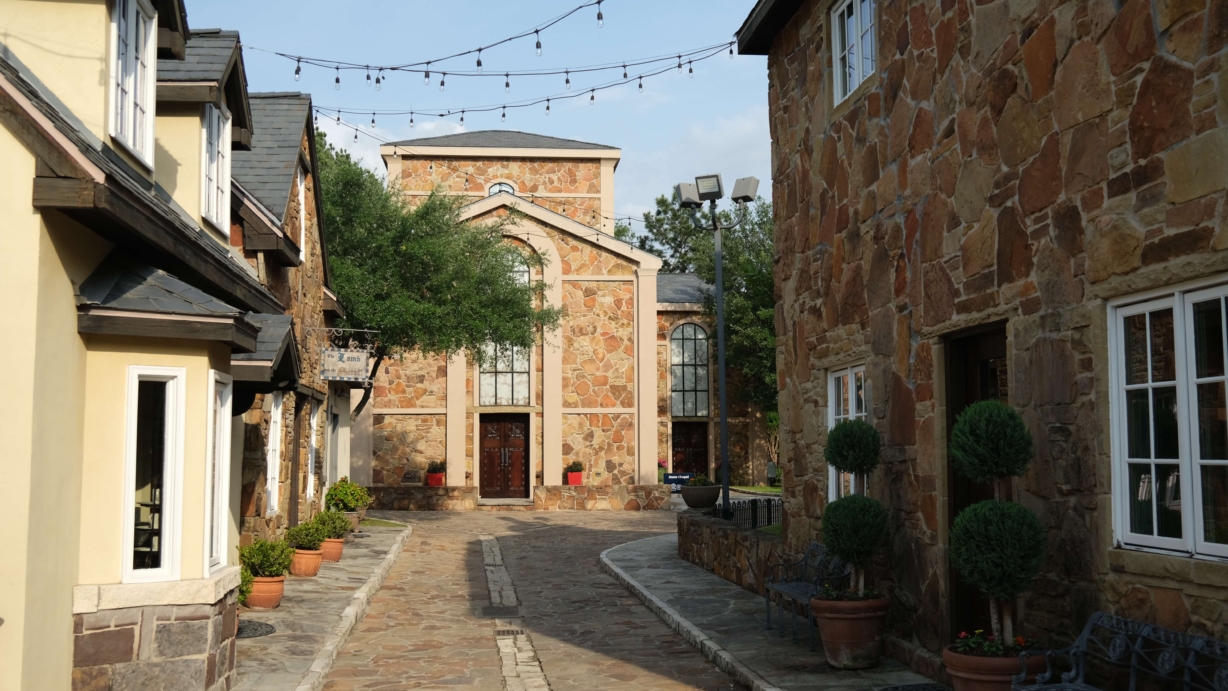 English style buildings line either side of a stone walkway leading to the Stone Chapel.