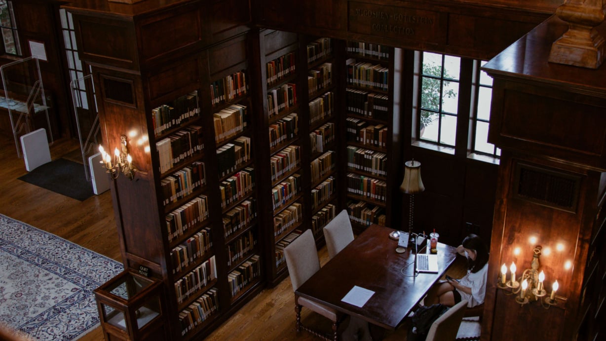 A woman studying at a table.